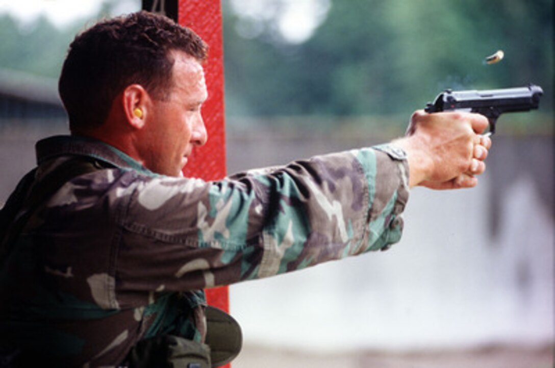 Staff Sgt. Tony Rodgers, of the 23rd Special Tactics Squadron, fires his 9mm pistol as part of the biathlon competition at Airlift Rodeo '96 on June 24, 1996. Airlift Rodeo '96 is the United States Transportation Command's tanker/airlift competition which tests the flight and ground skills of aircrews as well as the related skills of combat control, security police, aerial port, aeromedical evacuation, and maintenance team members. Crews from the U.S. and nine other countries are participating in the competition held this year at McChord Air Force Base, Wash. The 23rd is based at Hurlburt Field, Fla. 