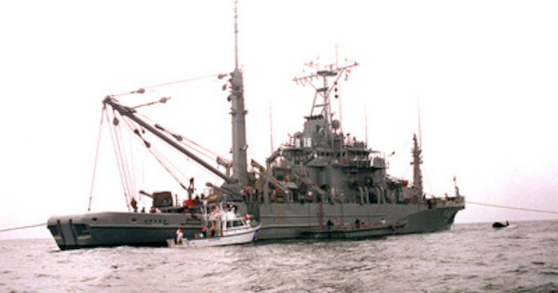 The U.S. Navy Salvage and Rescue ship USS Grasp (ARS-51) is anchored over the crash site of TWA Flight 800 offshore of Moriches Inlet, Long Island, N.Y., as it conducts diving operations on July 25, 1996. Navy divers are conducting dives recover victims of the crash and parts of the airplane to aid in the investigation. 