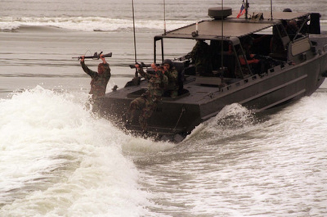 U.S. Marines from the 2nd Reconnaissance Company cast off of a Riverine Assault Craft during a Revised Capabilities Exercise at Camp Lejeune, N.C., on May 8, 1996. The Recon Marines and the assault craft are part of the 2nd Marine Division. 