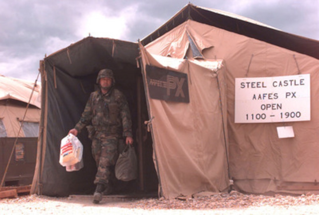 A U.S. Army soldier exits an Army Air Force Post Exchange at Steel Castle camp ground near Tuzla, Bosnia and Herzegovina, on May 23, 1996. U.S. troops are deployed to Bosnia and Herzegovina as part of the NATO Implementation Force (IFOR). The exchange, along with medical , financial, laundry, dining, and morale facilities have been erected for use by IFOR soldiers. 