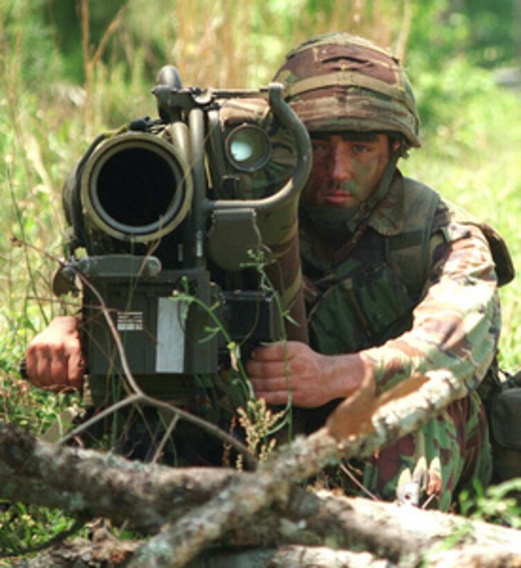 A British Royal Marine from 45 Commando watches for enemy tanks and armored personnel carriers from behind his anti-armor weapon at Camp Lejeune, N.C., on May 11, 1996, as part of Combined Joint Task Force Exercise '96. More than 53,000 military service members from the United States and the United Kingdom are participating in Combined Joint Task Force Exercise '96 on military installations in the Southeastern United States and in waters along the Eastern seaboard. 