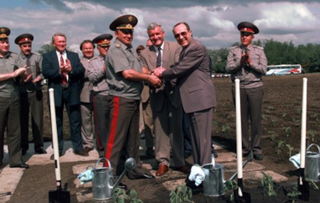 U.S. Secretary of Defense William J. Perry (right) Ukraine Minister of Defense Valeriy Shmarov (center) and Russian Federation Minister of Defense General of the Army Pavel Grachev (left) celebrate the completed dismantlement of Silo 110 by planting sunflowers in the field where the missile silo used to be near Pervomaysk, Ukraine, June 4, 1996. Silo 110 was one of 160 Ukrainian missile silos being dismantled under the Nunn-Lugar/Cooperative Threat Reduction Program. All 160 should be dismantled within the next two years 
