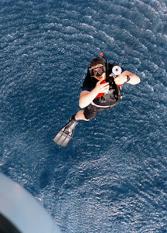 Petty Officer 3rd Class Keith Tourney, a Search and Rescue swimmer, is hoisted from the water up to a CH-46D Sea Knight helicopter during a training exercise in the Red Sea on May 9, 1996. Tourney is an Aviation Structural Mechanic attached to Helicopter Support Squadron 8, Naval Air Station Norfolk, Va. The aircraft was flying from the deck of ammunition ship USS Mount Baker (AE 34). 