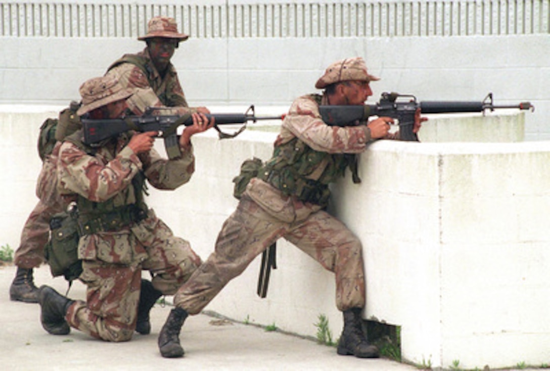 U.S. Marines, acting as opposing forces, lay down fire suppression during an assault by British Gurkhas on the Military Operations on Urbanized Terrain facility at Camp Lejeune, N.C., during Combined Joint Task Force Exercise '96 on May 13, 1996. More than 53,000 military service members from the United States and the United Kingdom are participating in Combined Joint Task Force Exercise '96 on military installations in the Southeastern United States and in waters along the Eastern seaboard. The Marines are attached to Fox Company, 2nd Battalion, 6th Marines, 2nd Marine Division. 
