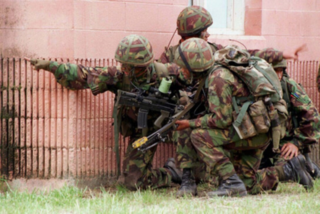 British Gurkhas prepare to enter a building as they assault the Military Operations on Urbanized Terrain facility at Camp Lejeune, N.C., during Combined Joint Task Force Exercise '96 on May 13, 1996. More than 53,000 military service members from the United States and the United Kingdom are participating in Combined Joint Task Force Exercise '96 on military installations in the Southeastern United States and in waters along the Eastern seaboard. 