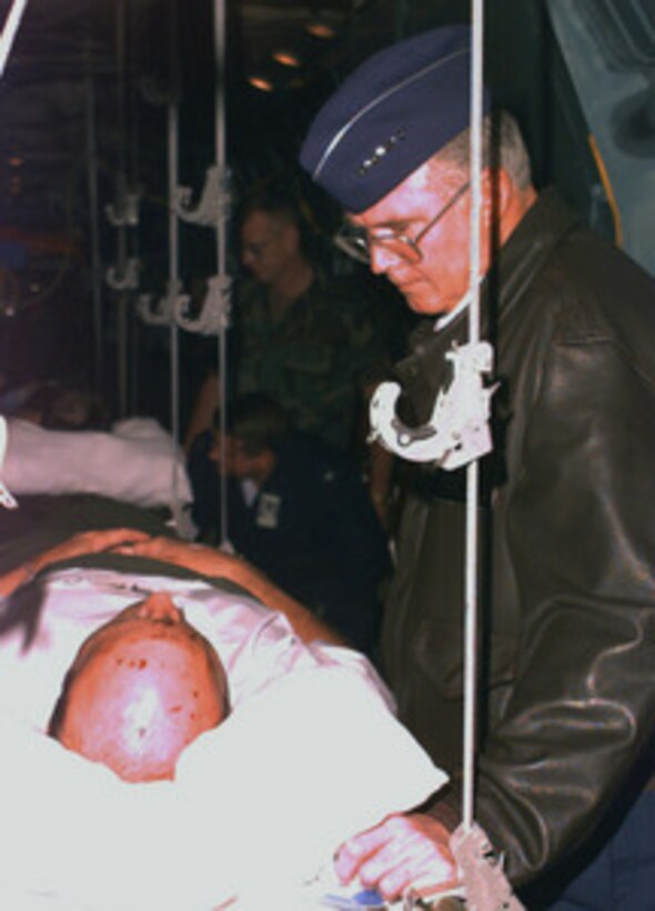 U.S. Air Forces in Europe Commander Gen. Michael Ryan consoles one of the Air Force airman injured in the Khobar Towers explosion as their medical evacuation plane arrives at Ramstein Air Base, Germany, on June 28, 1996, from Dhahran, Saudi Arabia. The injured will be transferred to Landstuhl Army Medical Center, Landstuhl, Germany, for further treatment. Aircraft from the 86th Aeromedical Evacuation Squadron transported the injured. 