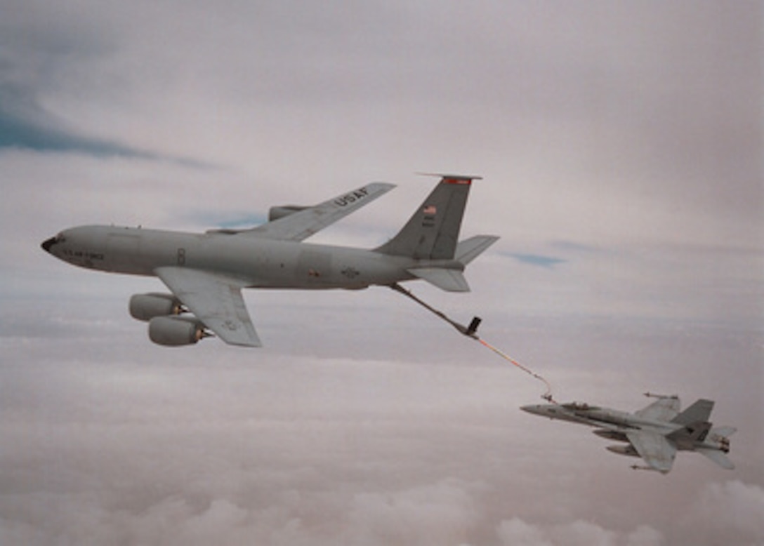 A U.S. Air Force KC-135 tanker refuels a U.S. Navy F/A-18C from Strike Fighter Squadron One Three One (VFA-131) in the skies over Saudi Arabia on April 24, 1996. The aircraft were operating in support of Operation Southern Watch. The F/A-18C, also known as the Hornet, was preparing to fly a patrol mission enforcing the no-fly zone over southern Iraq. VFA-131 is operating from the USS George Washington (CVN 73) which is currently deployed to the Arabian Gulf in suppport of Operation Southern Watch. 