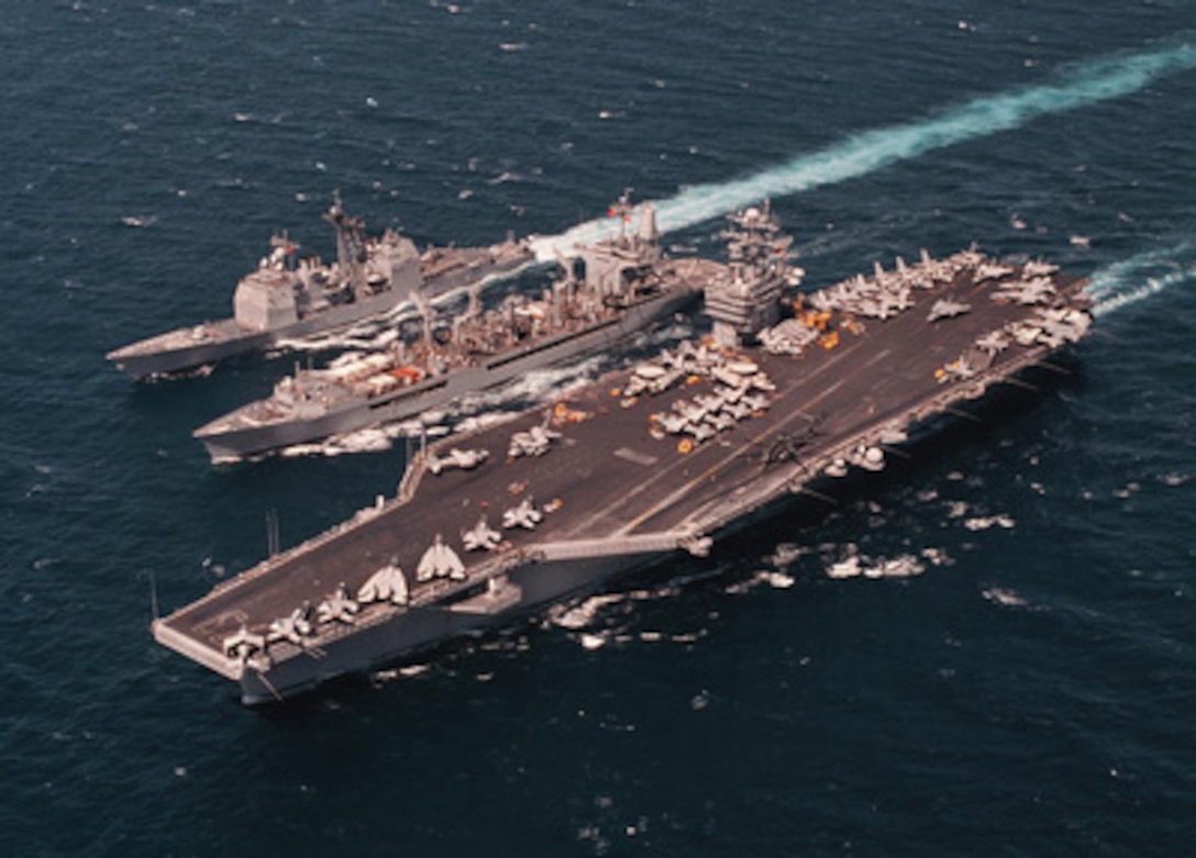 The fleet oiler USS Merrimack (AO 179) (center) provides fuel to guided missile cruiser USS San Jacinto (CG 56) (left) and aircraft carrier USS George Washington (CVN 73) (right) during replenishment at sea operations in the Arabian Gulf on April 29, 1996. The three U.S. Navy ships are currently deployed to the Arabian Gulf in support of Operation Southern Watch. 