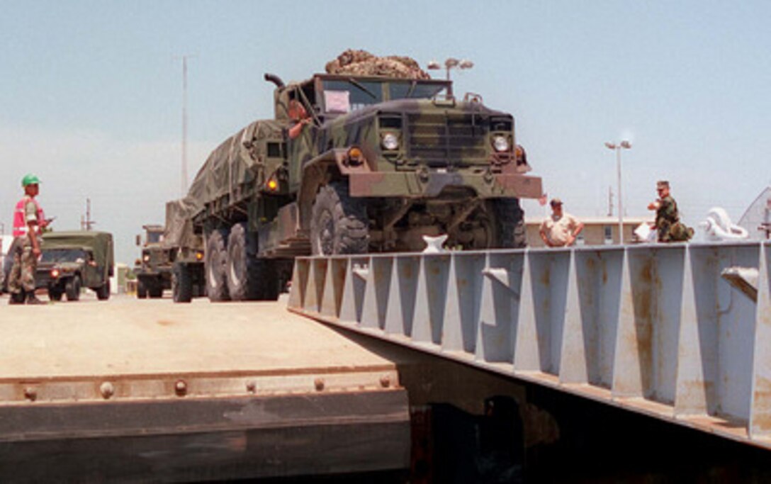 A U.S. Marine Corps M913 5-ton truck from the Mobile Combat Service Support Detachment, drives onto the ramp leading to the well deck of the USS Whidbey Island (LSD 41) at Morehead City, N.C., on May 4, 1996, for Combined Joint Task Exercise 96. More than 53,000 military service members from the United States and the United Kingdom are participating in Combined Joint Task Force Exercise 96 on military installations in the Southeastern United States and in waters along the Eastern seaboard. 