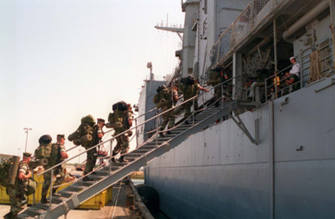 U.S. Marines from the 2nd Combat Engineer Battalion climb the brow of the USS Whidbey Island (LSD 41) at Morehead City, N.C., on May 4, 1996, for Combined Joint Task Exercise 96. More than 53,000 military service members from the United States and the United Kingdom are participating in Combined Joint Task Force Exercise 96 on military installations in the Southeastern United States and in waters along the Eastern seaboard. 