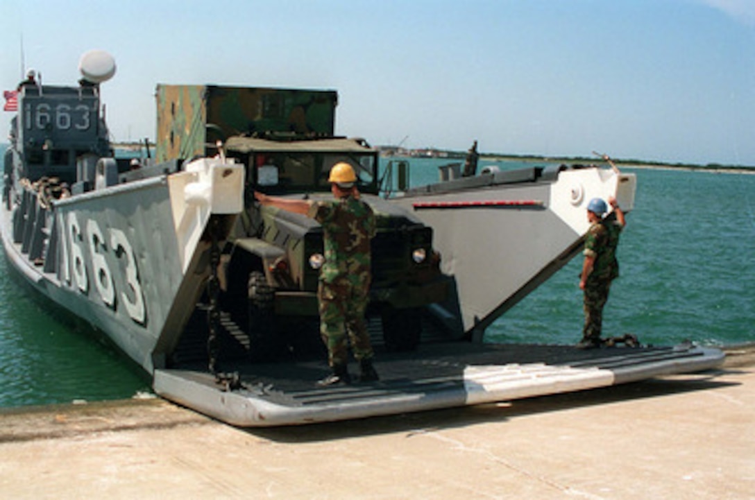 U.S. Marine vehicles from the 2nd Force Service Support Group load on U.S. Navy Landing Craft Utility 1663 at Radio Island near Morehead City, N.C., on May 4, 1996, for Combined Joint Task Exercise 96. More than 53,000 military service members from the United States and the United Kingdom are participating in Combined Joint Task Force Exercise 96 on military installations in the Southeastern United States and in waters along the Eastern seaboard. 