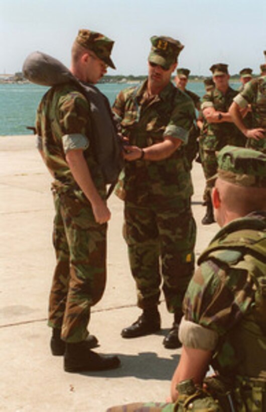 A crew member from U.S. Navy Landing Craft Utility 1663 gives a class on the proper wear and fit of a life preserver to U.S. Marines at Radio Island near Morehead City, N.C., on May 4, 1996, for Combined Joint Task Exercise 96. More than 53,000 military service members from the United States and the United Kingdom are participating in Combined Joint Task Force Exercise 96 on military installations in the Southeastern United States and in waters along the Eastern seaboard. The landing craft will transport Marines from the 2nd Marine Division to the USS Nassau (LHA 4) for the exercise. 