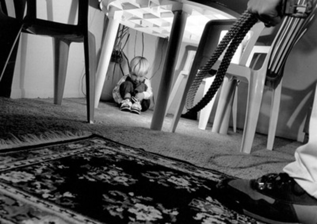 Honorable Mention Illustrative  'A Child's Black Cloud' by Staff Sgt. James D. Mossman, U.S. Air Force.  This photograph was done for a story on child abuse. It is one of three photographs in a series and was taken with the intention off showing the fear and pain a child might experience at the hands of an abusive adult.