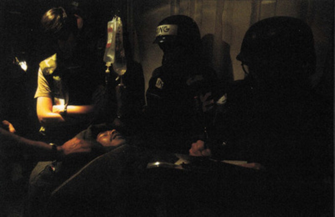 Honorable Mention Combat Camera  'Healing Shelter' by Master Sgt. Michael J. Haggerty, U.S. Air Force.  A Bangladeshi Peacekeeper critically wounded near Tuzla, Bosnia and Herzegovina, is cared for in an air raid shelter while the Serbians attacked Zagreb, Croatia.
