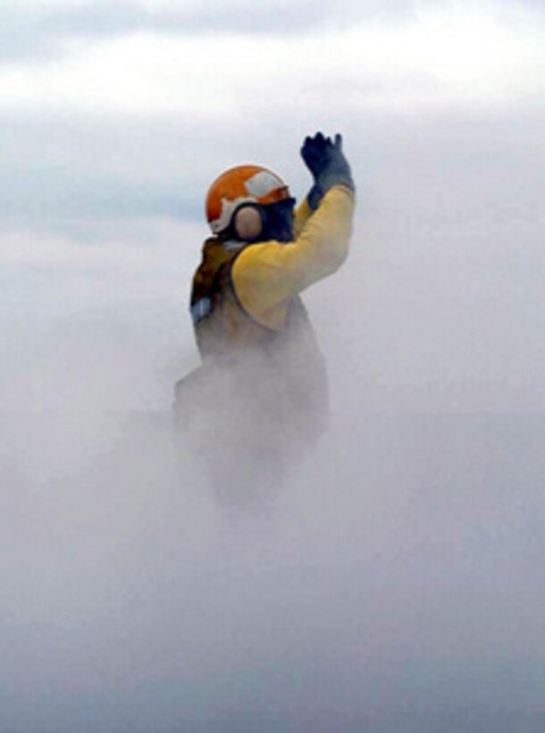 A flight deck handling officer on board the USS Enterprise (CVN 65) is engulfed in steam while directing aircraft onto the number one steam driven catapult during flight operations on April 27, 1996, while the ship is underway for Combined Joint Task Force Exercise '96. More than 53,000 military service members from the United States and the United Kingdom are participating in Combined Joint Task Force Exercise 96 on military installations in the Southeastern United States and in waters along the Eastern seaboard. 