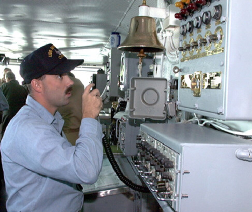 Petty Officer 3rd Class Jerry Watkins delivers a message to the crew from the bridge of the aircraft carrier USS Enterprise (CVN 65) on April 27, 1996, while the ship is underway for Combined Joint Task Force Exercise '96. More than 53,000 military service members from the United States and the United Kingdom are participating in Combined Joint Task Force Exercise 96 on military installations in the Southeastern United States and in waters along the Eastern seaboard. Watkins is a Navy Boatswain's Mate assigned to the Enterprise. 