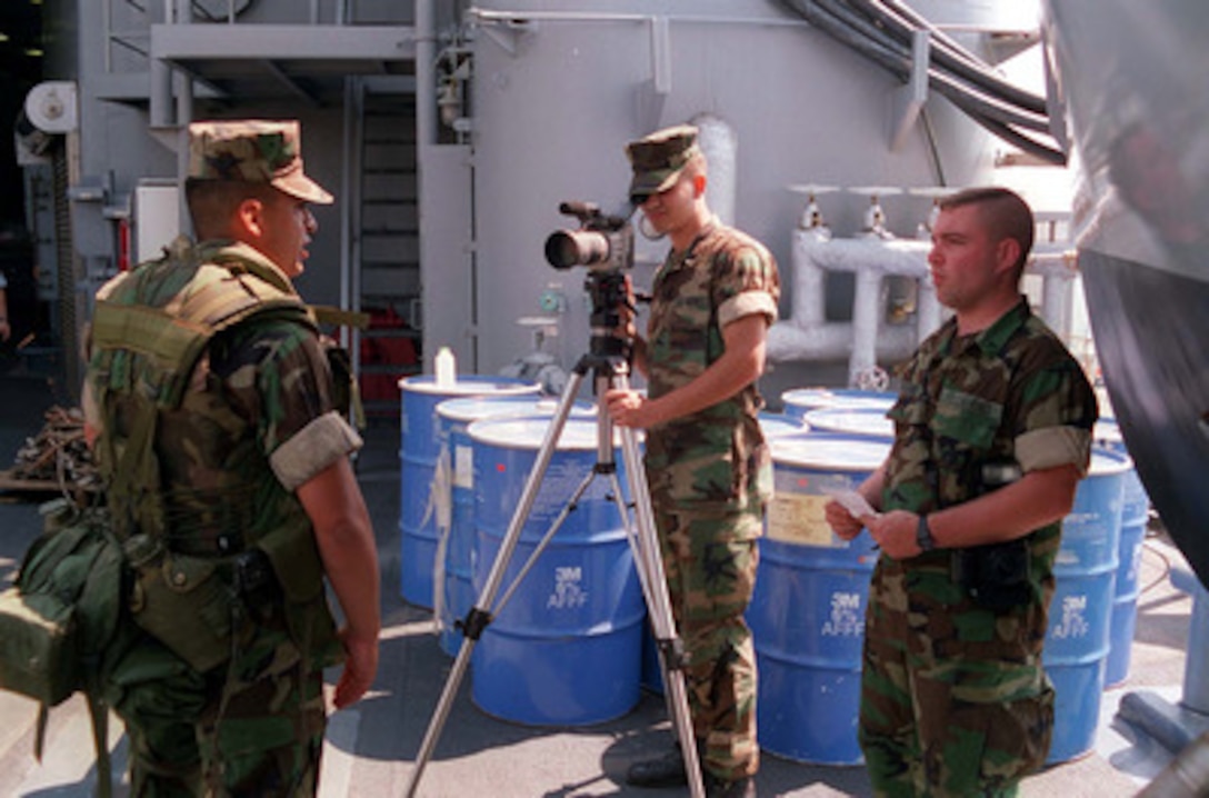 2nd Marine Division Combat Cameramen Cpl. Michael Rix and Lance Cpl. Matthew Sunderland interview a Marine during the embarkation of his platoon on board the USS Whidbey Island (LSD 41) at Radio Island near Morehead City, N.C., on May 4, 1996, for Combined Joint Task Exercise 96. More than 53,000 military service members from the United States and the United Kingdom are participating in Combined Joint Task Force Exercise 96 on military installations in the Southeastern United States and in waters along the Eastern seaboard. 