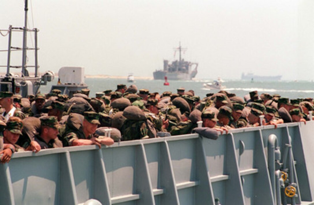 U.S. Marines from Bravo Company, Battalion Landing Team 1/8 wait aboard a U.S. Navy Landing Craft Utility that will transport them to the USS Nassau (LHA 4) from Radio Island near Morehead City, N.C., on May 4, 1996, for Combined Joint Task Exercise 96. More than 53,000 military service members from the United States and the United Kingdom are participating in Combined Joint Task Force Exercise 96 on military installations in the Southeastern United States and in waters along the Eastern seaboard. 