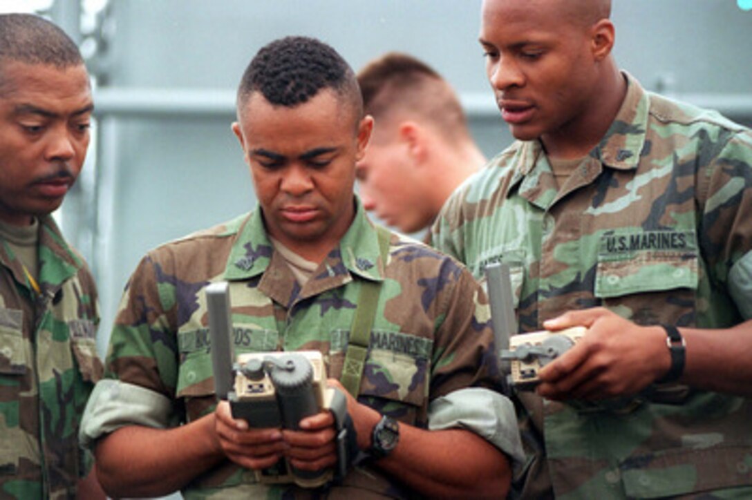 Marine Sgt. E. Richards (center) shows Gunnery Sgt. A. Terry (left) and Cpl. I. Bates (right) a handheld Global Positioning System while aboard the USS La Moure County (LST 1194) for Combined Joint Task Force Exercise '96 on May 6, 1996. More than 53,000 military service members from the United States and the United Kingdom are participating in Combined Joint Task Force Exercise 96 on military installations in the Southeastern United States and in waters along the Eastern seaboard. 