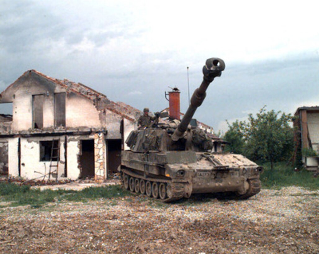 U.S. Army Pfc. Glenn Garrity mans the .50-caliber machine gun mounted on a M-109A3 155mm self-propelled howitzer at McGill Base in Bosnia and Herzegovina on May 9, 1996. Garrity, from A Battery, 2nd Battalion, 3rd Field Artillery, is deployed as part of the NATO Implementation Force (IFOR) in Bosnia and Herzegovina. The M-109A3 is an armored self-propelled medium howitzer which fires a shell about 6.2 inches in diameter. 