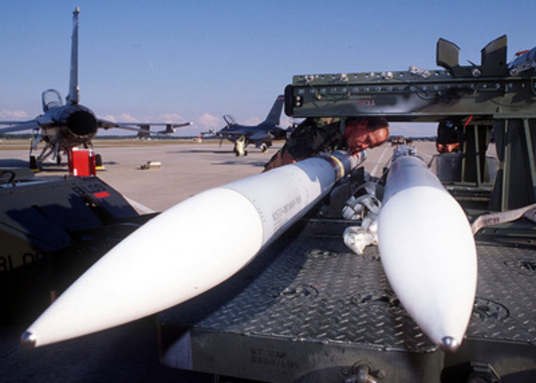 Master Sgt. Kevin Nelson inspects an AIM 120 Advanced Medium-Range Air-to-Air Missile before loading it onto a F-16 Fighting Falcon at Tyndall Air Force Base, Fla., on Oct. 22, 1996, during William Tell '96. William Tell is an annual competition designed to challenge the air-to-air capabilities of combat air forces and have their crews perform under simulated combat conditions. Nelson is a weapons load crew chief for the 119th Fighter Wing, Air National Guard. 