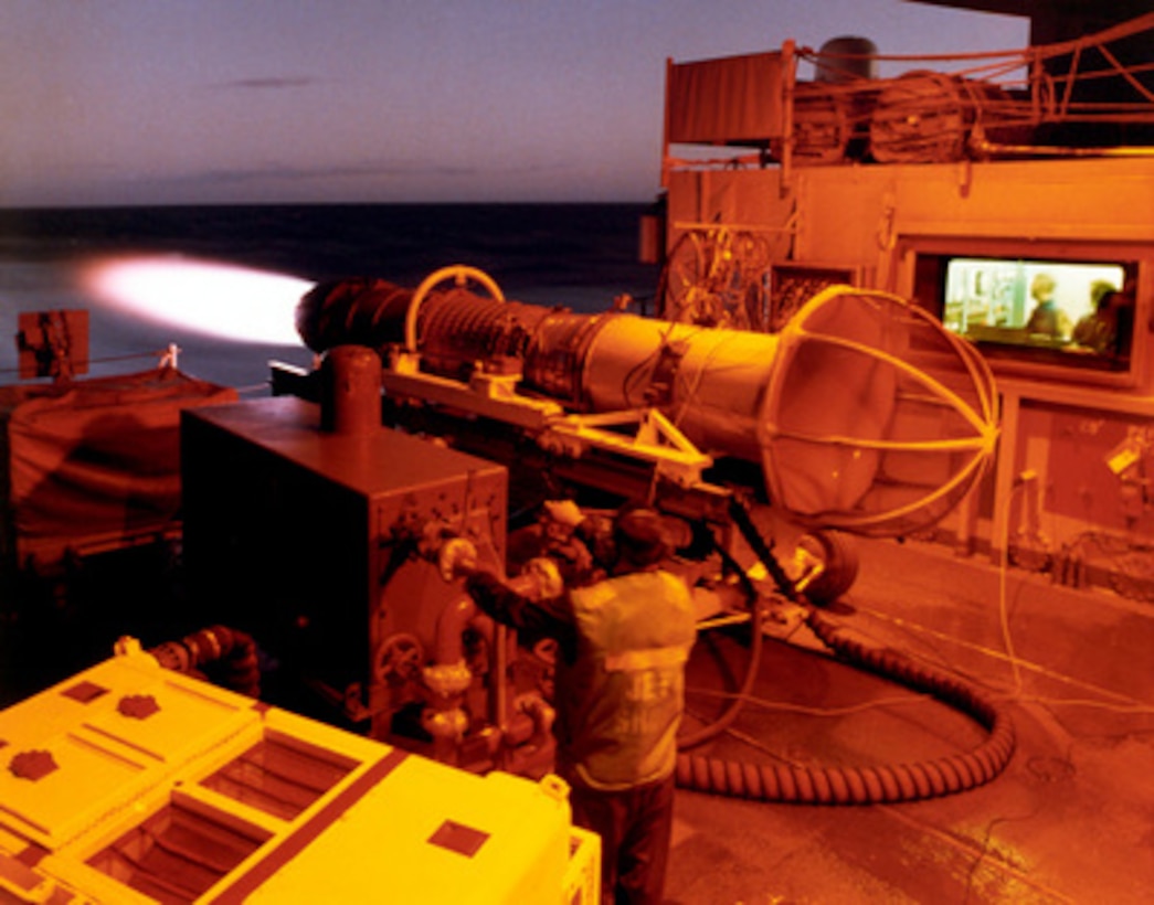 Petty Officer 3rd Class Anthony C. Nauta, U.S. Navy, fires up a jet engine in the engine test cell on the aircraft carrier USS Kitty Hawk (CV 63) as the ship steams toward the Western Pacific on Oct. 23, 1996. Nauta is performing a maintenance check on a F404-GE-400 engine used in the F/A-18 Hornet. Nauta, an aviation machinist mate from San Diego, Calif., is assigned to the Aviation Intermediate Maintenance Department. The Kitty Hawk and its battle group are currently en route to the Western Pacific and Persian Gulf on a regularly scheduled deployment to relieve the USS Carl Vinson (CVN 70) battle group. 