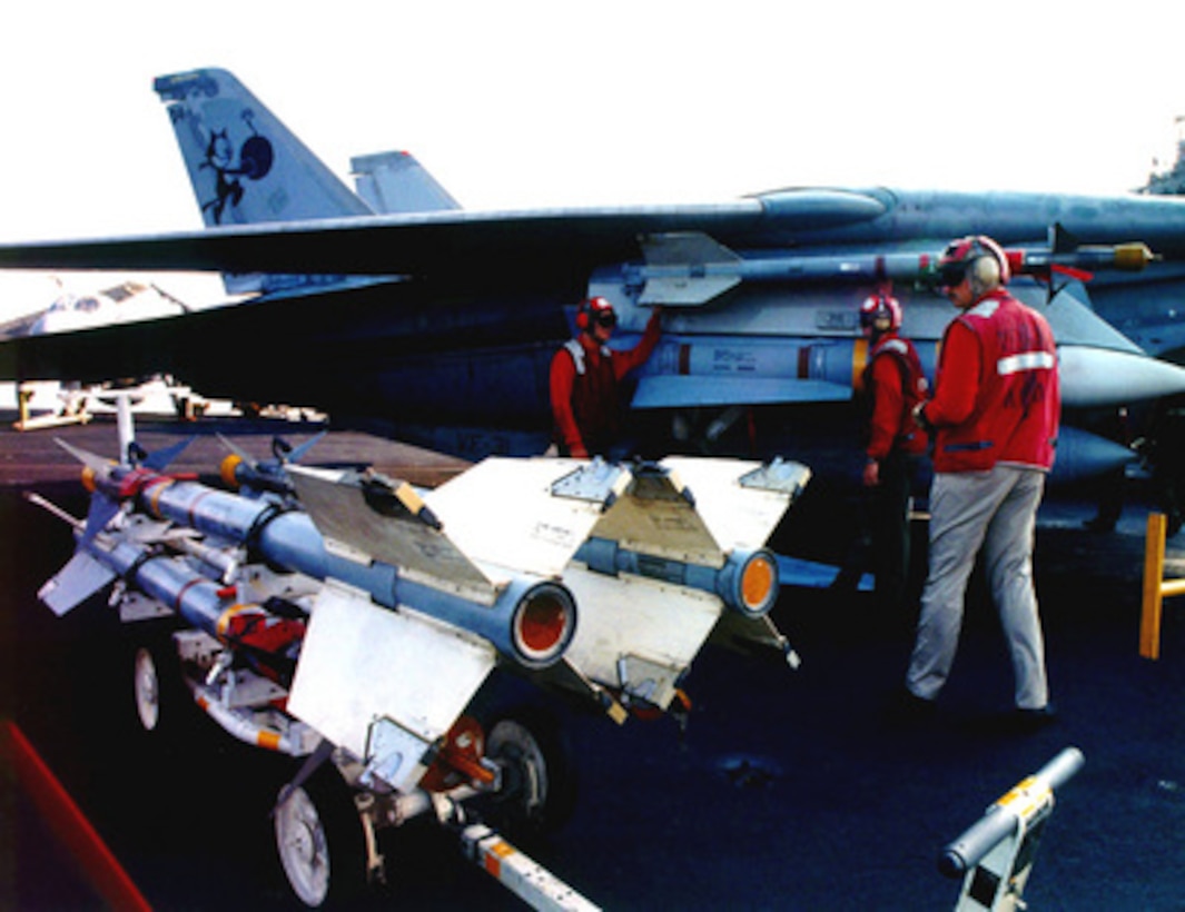 U.S. Navy aviation ordnancemen load Sidewinder and Phoenix missiles as they prepare an F-14 Tomcat for the first patrol of the extended no-fly zone over Iraq on Sept. 4, 1996. President Clinton announced an expanded no-fly zone in response to an Iraqi attack against a Kurdish faction. The larger no-fly zone in Southern Iraq will make it easier for U.S. and coalition partners to contain Saddam Hussein's aggression. The Fighter Squadron 31 Tomcat is operating from the flight deck of the aircraft carrier USS Carl Vinson (CVN 70) deployed to the Persian Gulf in support of Operation Southern Watch. 