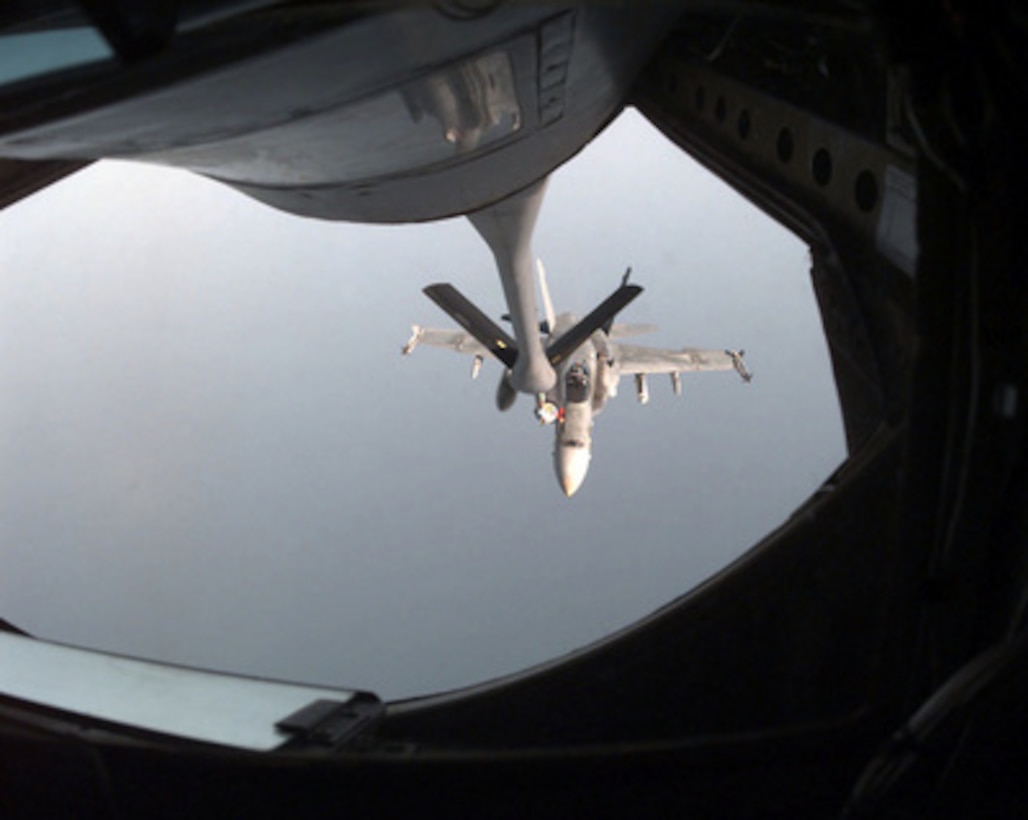 A U.S. Navy F/A-18 Hornet hooks into the drogue receptacle and begins to receive fuel during an in-flight refueling from a U.S. Air Force KC-135 Stratotanker on Aug. 27, 1996, over the Persian Gulf. The Hornet is patrolling the no-fly zone in Southern Iraq as part of Operation Southern Watch. The Hornet is operating from the flight deck of the USS Carl Vinson (CVN 70). The Carl Vinson and its battle group are operating in the Persian Gulf where they are conducting air patrols in support of Southern Watch. The Stratotanker, from the 4408 Air Refueling Squadron, is operating from Prince Sultan Air Base, Al Kharj, Saudi Arabia. 