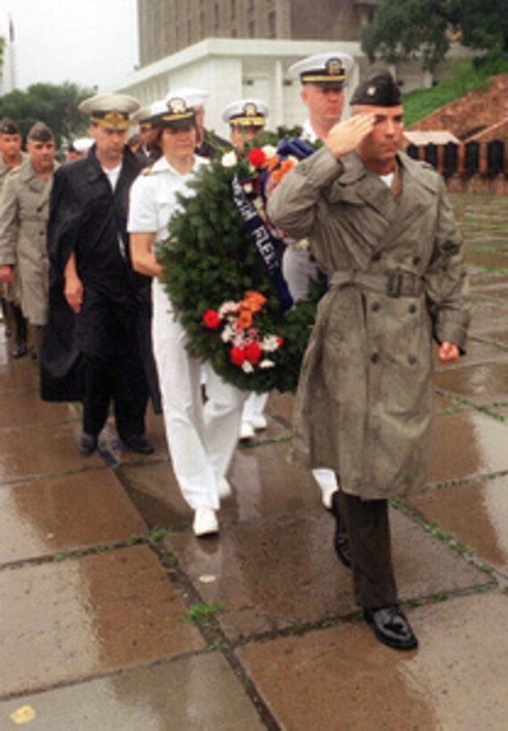 U.S. Marine Corps Capt. Jim Munroe leads a group of U.S. and Russian officers taking part in a wreath laying ceremony at a World War II memorial in Vladivostok, Russia, on Aug. 13, 1996, during Exercise Cooperation From the Sea '96. U.S. Navy and Marine Corps units of the 7th Fleet and Russian Federation Navy units are conducting the exercise near the port city of Vladivostok. The purpose of the exercise is to improve interoperability with Russian military forces in conducting disaster relief and humanitarian missions. Personnel exchanges and training will promote cooperation and understanding between the U.S. and Russian Federation Naval Forces. 
