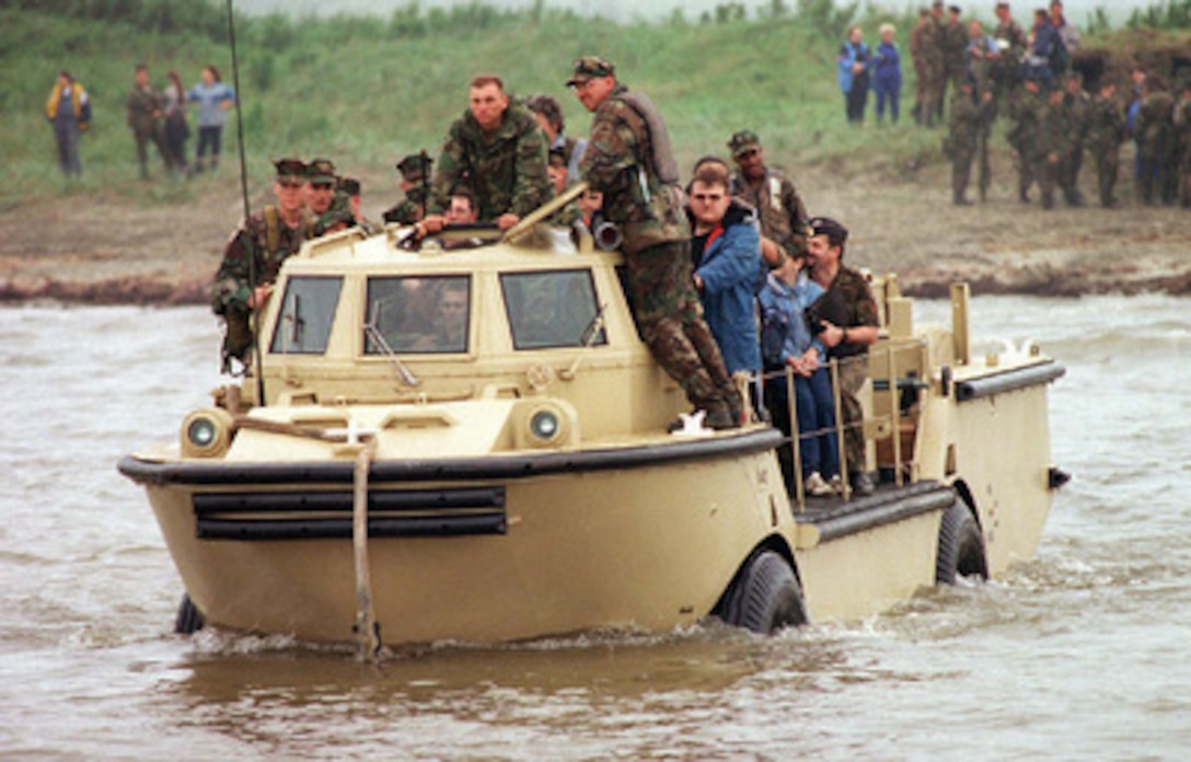 A Light Amphibious Reconnaissance Craft filled with U.S. sailors, Marines and Russian media departs the shores of a mock disaster area for a U.S. landing craft during Exercise Cooperation From the Sea '96 near Vladivostok, Russia, on Aug. 14, 1996. The simulated disaster area was designed for Russian and U.S. medical personnel and Marines to conduct joint relief efforts to a small community struck by natural disaster. The purpose of the exercise is to improve interoperability with Russian military forces in conducting disaster relief and humanitarian missions. Personnel exchanges and training will promote cooperation and understanding between the U.S. and Russian Federation Naval Forces. 
