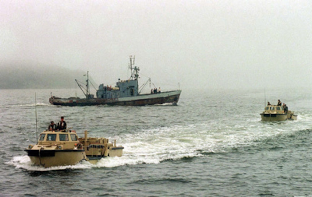 Two U.S. Navy Light Amphibious Reconnaissance Craft (LARC) ferry past a Russian fishing boat as they return from beach landings on Aug. 14, 1996, during Exercise Cooperation From the Sea '96 near Vladivostok, Russia. U.S. Navy and Marine Corps units of the 7th Fleet and Russian Federation Navy units are conducting the exercise near the port city of Vladivostok. The purpose of the exercise is to improve interoperability with Russian military forces in conducting disaster relief and humanitarian missions. Personnel exchanges and training will promote cooperation and understanding between the U.S. and Russian Federation Naval Forces. 