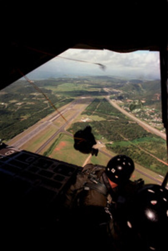 Explosive Ordnance Disposal technicians perform a static line jump from C-130 Hercules aircraft over Naval Station Roosevelt Roads, Puerto Rico, on March 17, 1997. Team members from Explosive Ordnance Disposal Mobil Unit 2 are practicing various methods of insertion and recovery in the naval station area. 