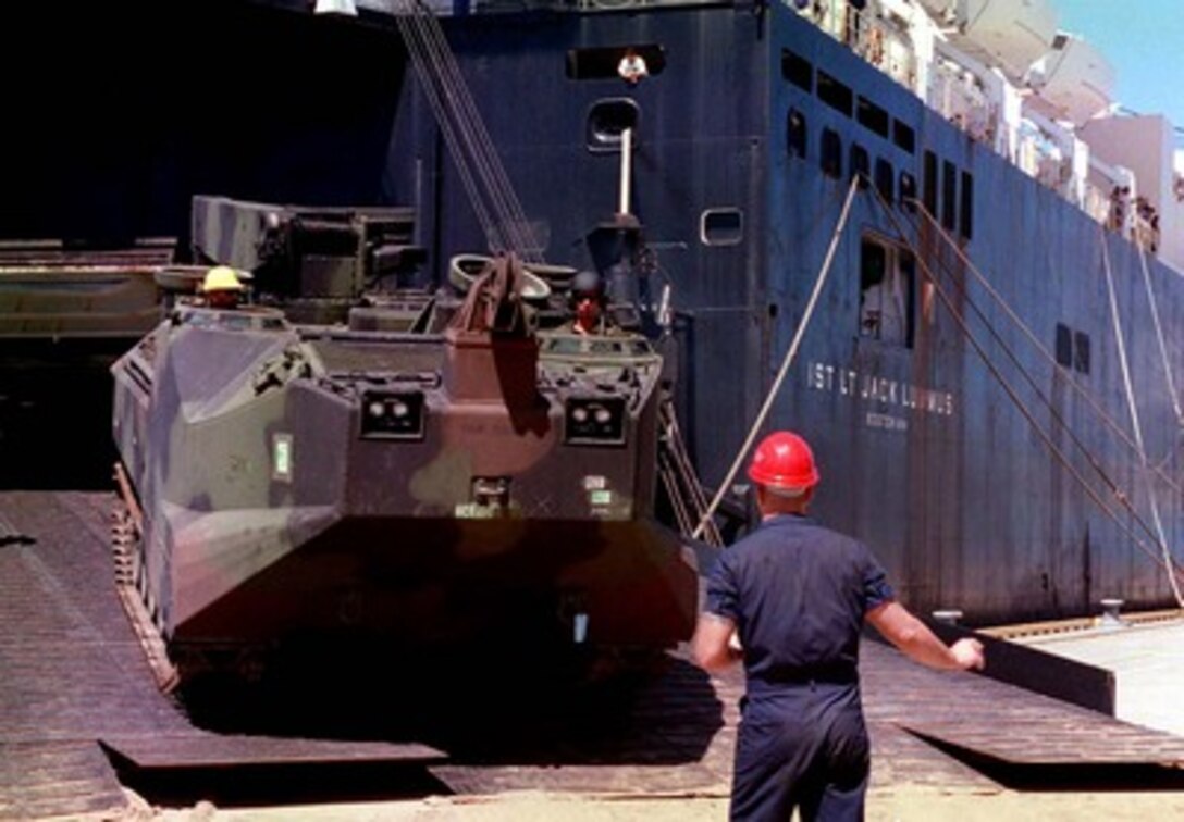 A U.S. Marine Corps Assault Amphibian Vehicle Recovery Model 7A1 is directed down the ramp of the M.V. 1st Lt. Jack Lummus docked at Boyne Smelter Pier, Gladstone, Australia, on March 1, 1997. Nearly 140 vehicles are being unloaded from the Maritime Prepositioning Force ship for use in exercise Tandem Thrust '97. Tandem Thrust is a combined military training exercise involving 28,000 personnel, 252 aircraft and 43 ships, and is designed to train U.S. and Australian staffs in crisis action planning and contingency response operations. 
