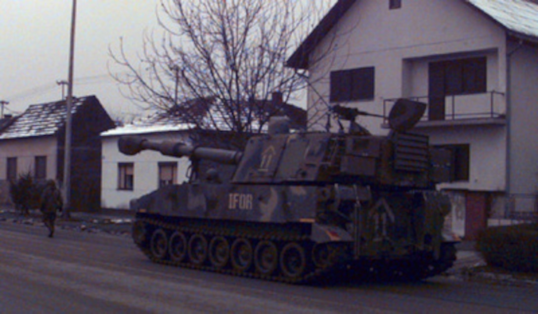 A U.S. Army M-109 155mm Self-propelled Howitzer rolls through the streets of Zupanja, Croatia, as it heads towards the pontoon bridge on the Sava River on Jan. 2, 1996. The howitzer will join the NATO Implementation Force (IFOR) deployment into Bosnia and Herzegovina for Operation Joint Endeavor. The howitzer, from the 2nd Battalion, 3rd Field Artillery of the 1st Armored Division, was transported to Zupanja by rail from Kirch-Goens, Germany. 