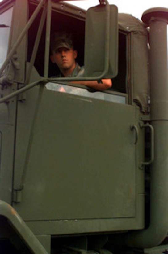 A Marine driver of an M-923A2 5-ton truck peers intently into his mirror as he backs off the M.V. Villars at the port facility in Paldiski, Estonia, on July 10, 1997, for Exercise Baltic Challenge 97. Baltic Challenge '97 is a multinational exercise conducted as a NATO Partnership for Peace initiative involving more than 2,600 military personnel from Denmark, Estonia, Finland, Latvia, Lithuania, Norway, Sweden, and the U.S. The focus of the training is peacekeeping tasks and humanitarian assistance operations. The Villars is bringing in equipment stored in Norway, as part of the Norway Air-Landed Marine Expeditionary Brigade Prepositioning Program. 
