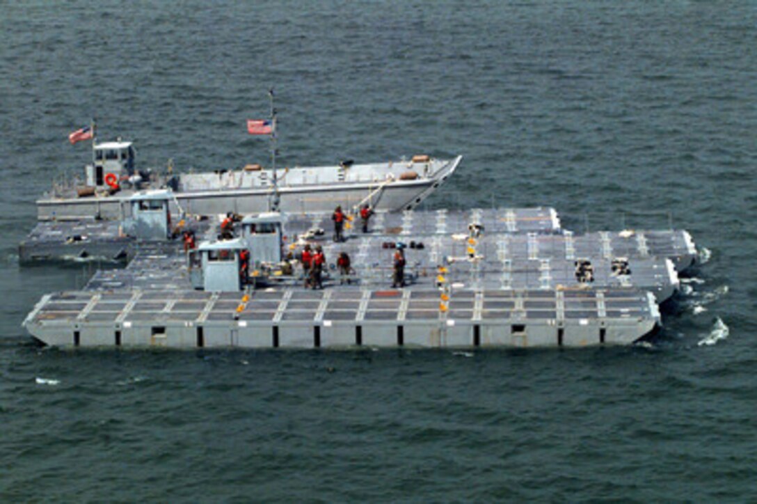 Lighter craft are moved to a staging area after being off loaded from the S.S. Sgt. Matej Kocak in the port of Paldiski, Estonia, on July 12, 1997, for Exercise Baltic Challenge 97. Baltic Challenge '97 is a multinational exercise conducted as a NATO Partnership for Peace initiative involving more than 2,600 military personnel from Denmark, Estonia, Finland, Latvia, Lithuania, Norway, Sweden, and the U.S. The focus of the training is peacekeeping tasks and humanitarian assistance operations. The lighter craft will be used to move equipment off-loaded from the Maritime Prepositioning Ships anchored off shore to the exercise area on the beach. 