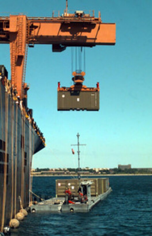 An ISO container is off loaded from the S.S. Sgt. Matej Kocak onto a lighter craft at the port facility in Paldiski, Estonia, on July 14, 1997, for Exercise Baltic Challenge 97. Baltic Challenge '97 is a multinational exercise conducted as a NATO Partnership for Peace initiative involving more than 2,600 military personnel from Denmark, Estonia, Finland, Latvia, Lithuania, Norway, Sweden, and the U.S. The focus of the training is peacekeeping tasks and humanitarian assistance operations. The lighter craft are being used to move equipment from the Maritime Prepositioning Ships to the exercise area on the beach. 