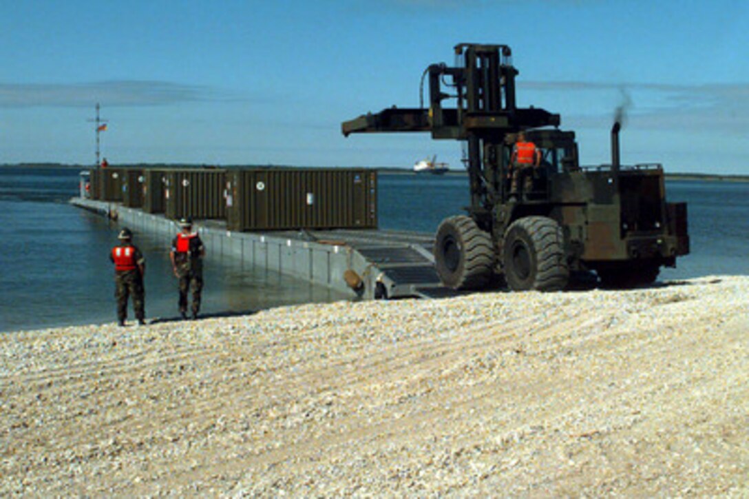 A Rough Terrain Cargo Handler crawls onto a lighter craft as it prepares to pull an ISO container brought ashore from the S.S. Sgt. Matej Kocak in Paldiski, Estonia, on July 15, 1997, for Exercise Baltic Challenge 97. Baltic Challenge '97 is a multinational exercise conducted as a NATO Partnership for Peace initiative involving more than 2,600 military personnel from Denmark, Estonia, Finland, Latvia, Lithuania, Norway, Sweden, and the U.S. The focus of the training is peacekeeping tasks and humanitarian assistance operations. The lighter craft are being used to move equipment from the Maritime Prepositioning Ships to the exercise area on the beach. 