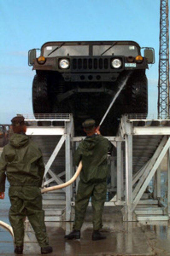 Two Marines use a fire hose to wash the underside of a Humvee on a wash rack at the port facility in Paldiski, Estonia, on July 17, 1997, during Exercise Baltic Challenge 97. All mud and dirt must be washed from the Humvee before it is reloaded onto the Maritime Prepositioning Ship S.S. Sgt. Matej Kocak anchored off shore. Baltic Challenge '97 is a multinational exercise conducted as a NATO Partnership for Peace initiative involving more than 2,600 military personnel from Denmark, Estonia, Finland, Latvia, Lithuania, Norway, Sweden, and the U.S. The focus of the training is peacekeeping tasks and humanitarian assistance operations. 
