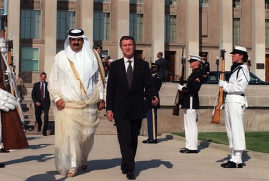 Secretary of Defense William S. Cohen escorts His Majesty Hamad bin Khalifa Al-Thani, the amir of Qatar, as they walk through a cordon of honor guards at the Pentagon, June 11, 1997. Cohen hosted the armed forces full honor ceremony to mark the Amir's first visit to the Department of Defense. Later he and the Amir, who also serves as his country's minister of defense, met to discuss a range of security issues of mutual interest to both nations. 