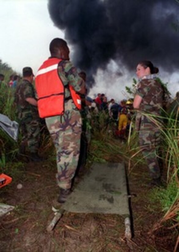 U.S. Navy and U.S. Air Force rescue personnel stand by to assist in the evacuation of casualties of Korean Airlines flight 801 on Aug 6, 1997.   U.S. Navy, U.S. Coast Guard, U.S. Air Force, and numerous civilian rescue teams, currently assisting in the search and rescue efforts of KAL flight 801, evacuated survivors from the crash site during the early morning of August 6th. 