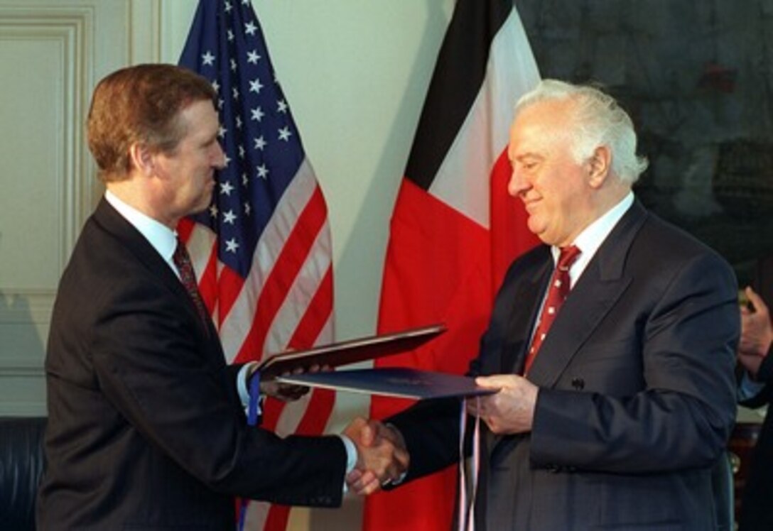 Having just signed a document entitled "Cooperation in the Area of Prevention of Proliferation of Weapons of Mass Destruction and Promotion of Defense and Military Relations," Secretary of Defense William S. Cohen (left) and President Eduard Shevardnadze of Georgia (right) exchange copies of the agreement. The signing ceremony was held at the Pentagon, July 17, 1997. 