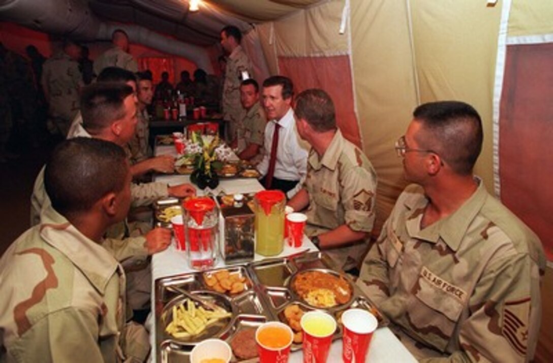 Secretary of Defense William S. Cohen lunches with U.S. troops at Prince Sultan Air Base, Kingdom of Saudi Arabia, on June 15, 1997. Secretary Cohen toured the base facilities and observed security measures taken. 