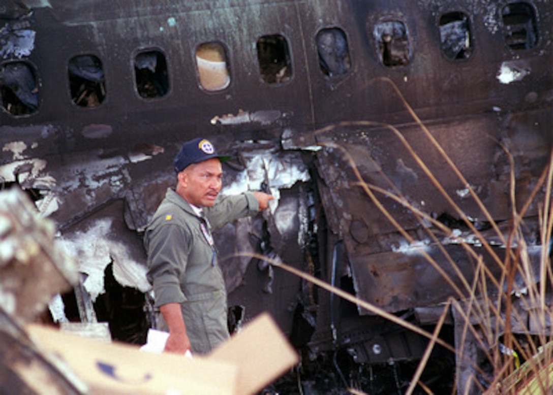 Disaster Preparedness Coordinator Lieutenant Commander Joe San Augustine, U.S. Navy, a native of Barrigada, Guam, directs workers at the crash of KAL Flight 801. U.S. Navy, Air Force, Coast Guard, local civilian disaster teams and National Transportation Safety Board (NTSB) officials continue crash and salvage operations at the KAL Flight 801 crash site in Guam. 