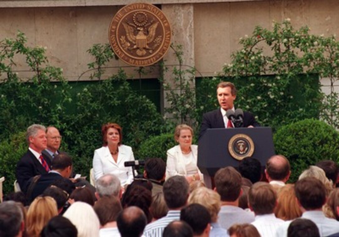 Secretary of Defense William Cohen, speaking at the U.S. Embassy in the company of President Bill Clinton (seated left), Secretary of State Madeleine Albright (seated right) and Ambassador and Mrs. Richard Gardner (seated left-center), recounts some of the historic developments of the day. Hours earlier, at the NATO summit, the presidents and prime ministers of the 16 member nations reached a consensus on inviting three nations, Poland, Hungary, and the Czech Republic, each a former satellite of the Soviet Union, to join the Western military alliance. It was hoped that the three selectees would be ready for full NATO integration by the turn of the century. the company of President Bill Clinton (seated left), Secretary of State Madeleine Albright (seated right) and Ambassador and Mrs. Richard Gardner (seated left-center), recounts some of the historic developments of the day. Hours earlier, at the NATO summit, the presidents and prime ministers of the 16 member nations reached a consensus on inviting three nations, Poland, Hungary, and the Czech Republic, each a former satellite of the Soviet Union, to join the Western military alliance. It was hoped that the three selectees would be ready for full NATO integration by the turn of the century. 