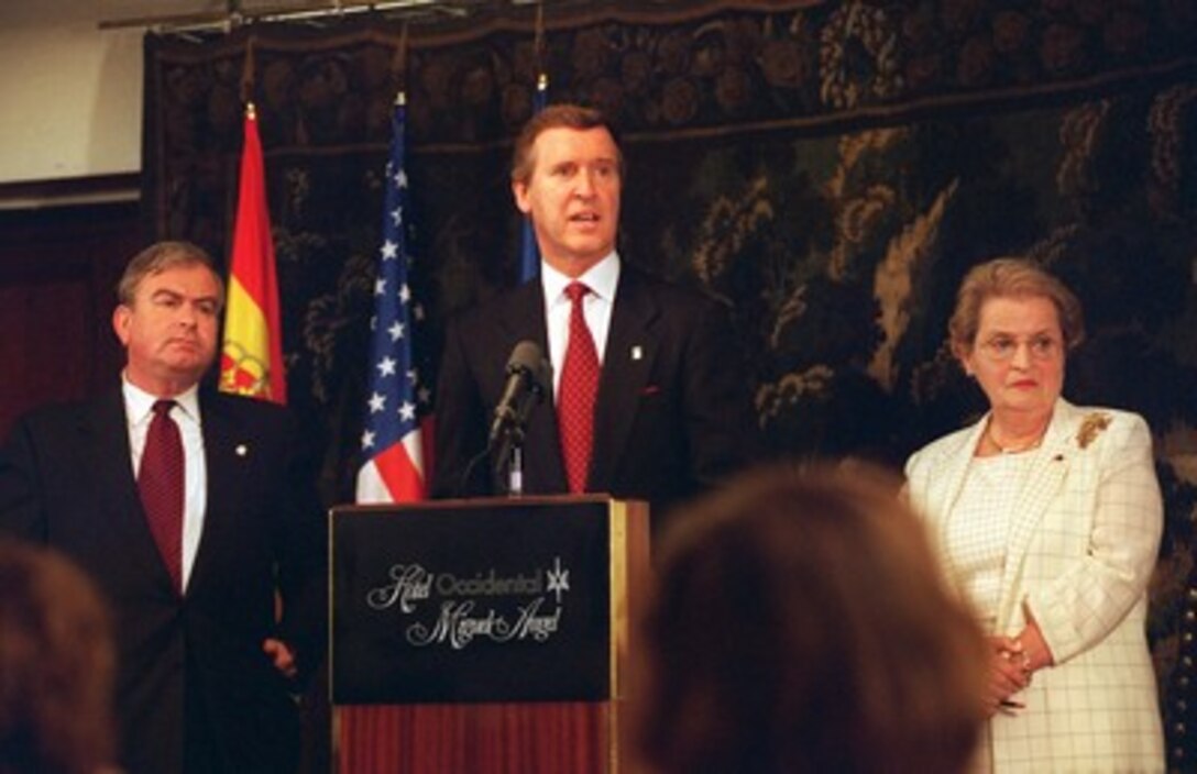 Secretary of Defense William Cohen, accompanied by National Security Advisor Samuel Burger (left) and Secretary of State Madeleine Albright (right), speaks during a press conference, held July 8, 1997, at the Miguel Angel Hotel, Madrid, Spain. The three policy leaders talked to reporters about the historic decision, made earlier in the day at the NATO summit, to invite Poland, Hungary, and the Czech Republic, three former members of the now defunct Warsaw Pact, to begin accession negotiations to join the NATO alliance. 