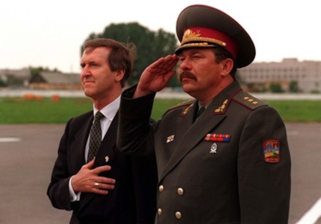 Secretary of Defense William Cohen (left) stands with Ukrainian Defense Minister Olexandr Kuzmuk as the National Anthem is played during arrival ceremonies at Borispil Airport, Kiev, Ukraine, July 11, 1997. Cohen visited Ukraine to attend the closing ceremonies of the NATO Partnership for Peace exercise Cooperative Neighbor, which involved the participation of American troops along with those from 12 other nations, and to meet with the Ukrainian leadership on a variety of security issues. 