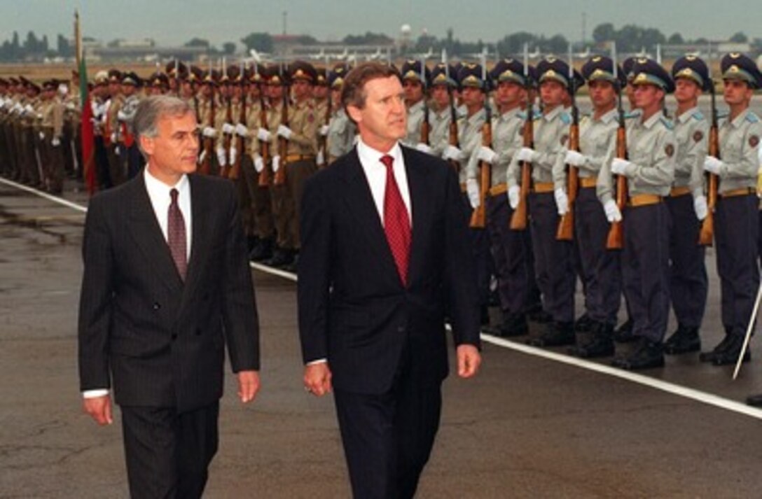 Secretary of Defense William Cohen (right), accompanied by Bulgarian Minister of Defense Georgi Ananiev (left), inspects the joint service Bulgarian honor guard assembled at the airport in Sofia for his arrival welcoming ceremony, July 12, 1997. Cohen visited the former Soviet satellite nation to see for himself the governmental reforms and planned programs of modernization which have elevated Bulgaria to the forefront among those countries seeking NATO membership. 