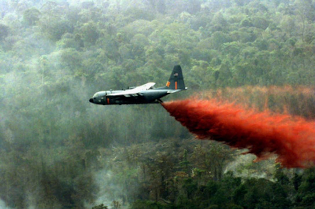 A Wyoming Air National Guard C-130 Hercules equipped with a Modular Airborne Fire Fighting System drops a water and fire retardant slurry on a fire on the Indonesian island of Sumatra on Nov. 17, 1997. Three C-130s and a total of 96 service members were sent to Indonesia for humanitarian support in fighting the jungle fires. The mission is providing the National Guard a first-time opportunity to fight forest fires internationally while using the Modular Airborne Fire Fighting Systems or MAFFS. Two of the C-130s are equipped with the U.S. Forest Service-owned MAFFS to douse fires from the air. The Wyoming Air National Guard's 153rd Airlift Wing is one of only four in the U.S. equipped to perform aerial fire fighting missions. 