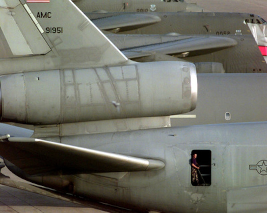 Senior Airman Ryan Coates relaxes in the aft door of a U.S. Air Force KC-10 Extender after a pre-flight inspection at Naval Support Facility Diego Garcia, British Indian Ocean Territory, on Dec. 10, 1997. The Extender is aerial refueling tanker and is deployed to Diego Garcia in support of Operation Southern Watch. Southern Watch is the U.S. and coalition enforcement of the no-fly-zone over Southern Iraq. Coates is deployed from the 660th Aircraft Generation Squadron, Travis Air Force Base, Calif. 